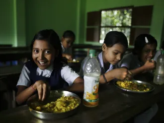 School children eat mid day meals at Mondalpara High School, Mondalpara Gaighata, West Bengal
