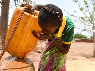 Children gathering water in the village of Naaba Guegma, in the Northern region of Burkina Faso.