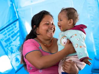 A mom holds her baby.