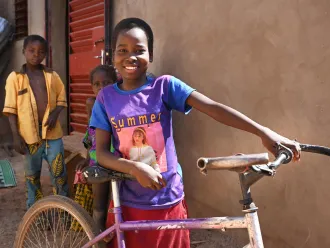 Awa Sobre, a 12 year old girl is very happy with her bicycle, in Dedougou, in the west of Burkina Faso.