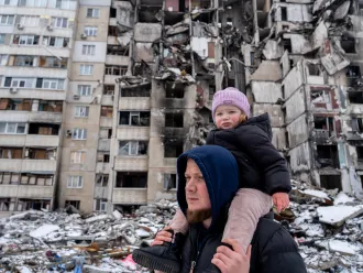 Oleksandr is on a walk in the courtyard with his two-year-old daughter Michelle in Saltivka, Ukraine.