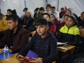 Children attending lessons at a UNICEF-supported tent classroom in a temporary shelter in Antakya, after two devastating earthquakes hit south-east Türkiye.