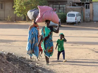 On 19 April 2023, people flee their neighbourhoods amid fighting between the army and paramilitaries in Khartoum, Sudan.