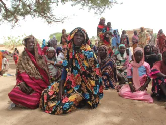 On 27 April 2023, as conflict escalates in Sudan, a group of refugees, mostly women and children, rest under a tree to protect themselves from the high temperatures after crossing into the Chadian village of Koufroun, which is situated on the Chad-Sudan border.