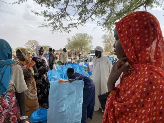 On 30 April 2023, 16-year-old Ikhram, right, waits in line to collect non-food items distributed by UNICEF and its partners in Kounfroun, Chad.
