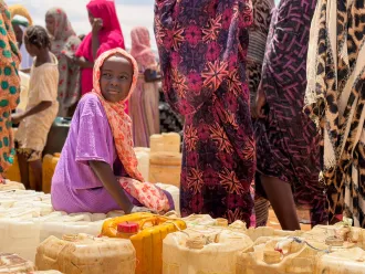 Children and women queue for water in Al Obeid, Sudan. 