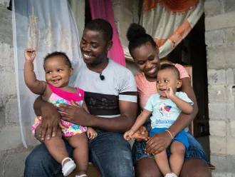 Guino Sylvain & Micherline Jean-Pierre, holding their twin children. Both assisted to a parenthood club to inform and prevent diseases coming from malnutrition. 