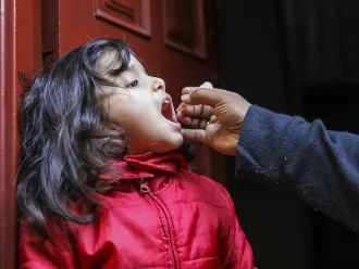A little girl receives a polio vaccine.
