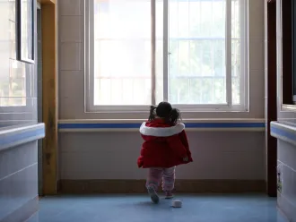 Five-year-old Yuanyuan walks the corridor of a hospital affiliated to the Wuhan University of Science and Technology in China.