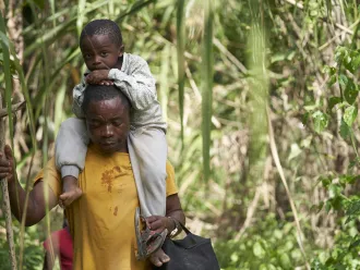 On 5 February 2020, Romeu Mauricio and his son, Jetfro, 3, cross through the Darien Gap jungle dividing Colombia and Panama.