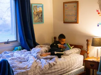 Luka reads in bed before starting his day.