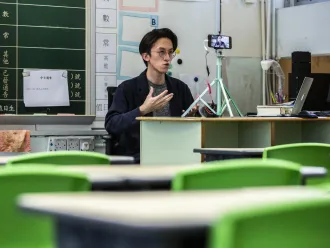 A primary school teacher records lessons for students in China.