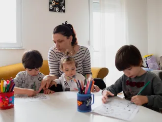 A mother in Macedonia helps her children study at home.
