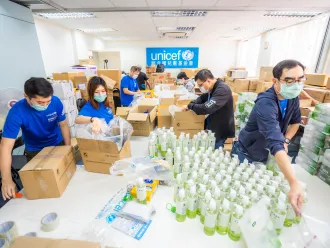 UNICEF workers sorting COVID-19 supplies