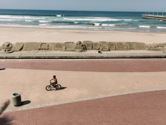 A lone cyclist rides along a beach in Durban.