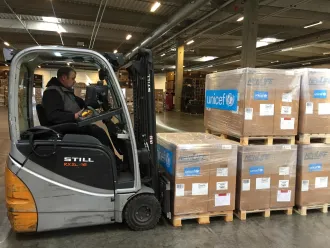 A UNICEF worker prepares to move supplies to be shipped to the DRC.