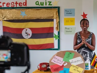 A teacher in Uganda records a lesson for a televised education broadcast.