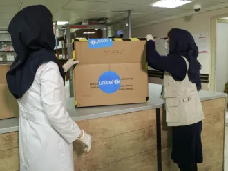 Health workers inspect a delivery of supplies.