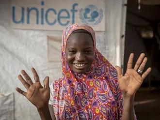 A youth advocate shows off her clean hands.