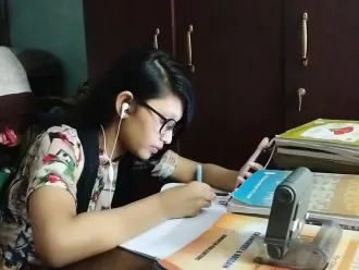 A girl studies at home.