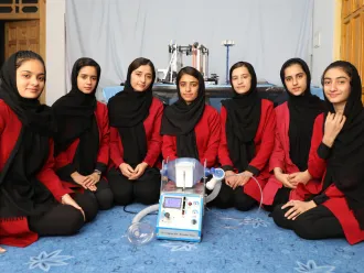 Members of the Afghan Dreamers team with their ventilator prototype.