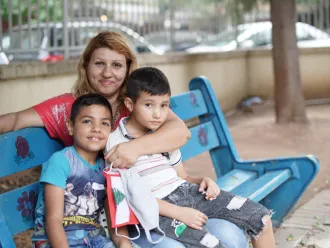 On 1 September 2020, Kevin, 8 years old, left, with his mother Nadida Kayyal Bakli and brother at the UNICEF's children friendly space (CFS) at the Karantina public garden in Beirut, Lebanon.