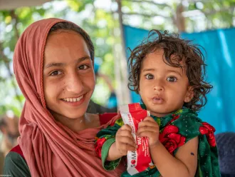 A child named Zarmina receives RUTF at UNICEF-supported mobile health and nutrition in Afghanistan. 