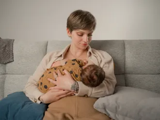 Irina from Moldova is breastfeeding her three-week-old daughter, firmly believing that breastfeeding is the best way to nourish a child during the first months of life.