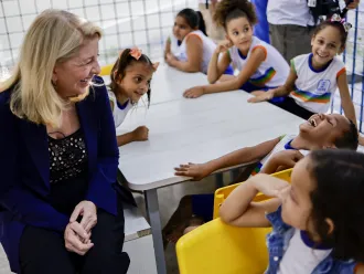 On 30 August 2023 in Brazil, UNICEF Executive Director Catherine Russell shares a good laugh with a student while visiting the CEMEI 8 de Março school in the Ibura neighbourhood of Recife.
