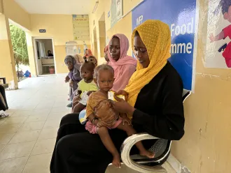 On 13 September 2023, mothers feed their children with ready-to-use therapeutic food (RUTF) at the Ahmed Gasim Health Centre in Port Sudan.