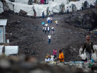 Displaced children on their way to school at the Lushagala IDP site in North Kivu province, DR Congo on 11 September 2023. UNICEF and its partners have set up temporary learning spaces in the site to allow displaced children to continue their learning.