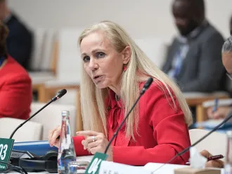 Kitty van der Heijden speaking at an event. 