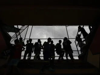 Silhouette of children standing on a balcony 