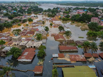 The image captures a Bird's eye-view of houses being flooded.