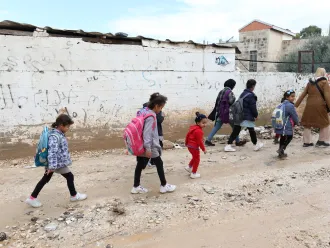 Des enfants retournent à l'école à pied au milieu des décombres dans les rues de Jénine, en Cisjordanie.