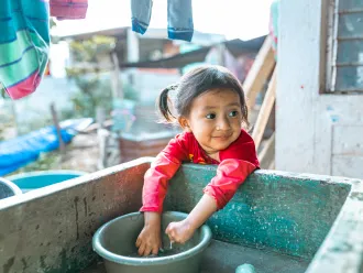 In the village of La Pistam Nebaj, María (2years old) washes her hands. 