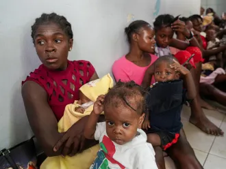 An image of mothers and children at La Paix University Hospital, where hundreds of mothers brought their children for screening and treatment of malnutrition. 