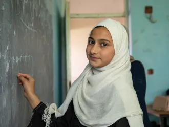 On 11 June 2024, primary school students in Kabul interact with other students and teachers.