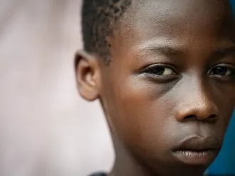 A child in Haiti looks towards the camera 