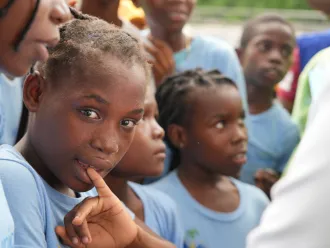A child in Haiti looks towards the camera. 