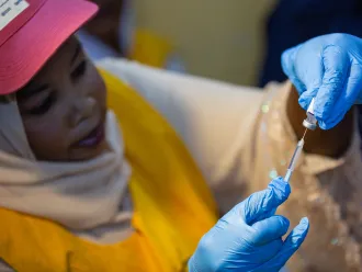 Health worker prepares malaria vaccines in Sudan