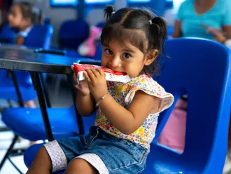 A girl eating Plumpy'Nut