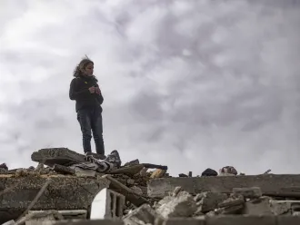 A Gazan child stands on top of rubble in Northern Gaza. 