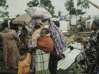 Families who had been living in displaced persons camps around Goma seek shelter on their way to Shasha village in North Kivu province, DR Congo