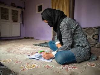 On February 10 2025, Ramzia*, 15, is drawing at home. She has been out of school for the past three and a half years. She was in eighth grade when girls were banned from school.