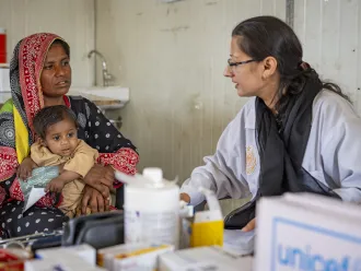 A mother with newborn getting doctor's assessment in Pakistan