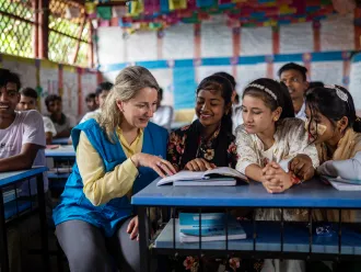 On 8 October 2025, at the Rohingya Refugee Camp in Cox’s Bazar, Bangladesh, UNICEF Private Fundraising and Partnerships Division Director, Carla Haddad Mardini, talks with young students during a visit to the Learning Centre..
