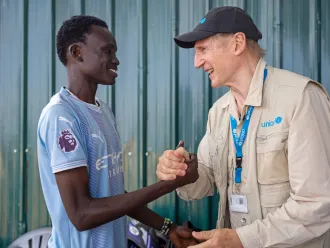UNICEF Goodwill Ambassador Liam Neeson meets 20-year-old Alan at the Gredo Youth Centre in Juba, South Sudan.