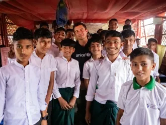 UNICEF Goodwill Ambassador Orlando Bloom pictured with Grade 9 children in Cox's Bazar who are at risk of losing access to education due to global funding cuts.