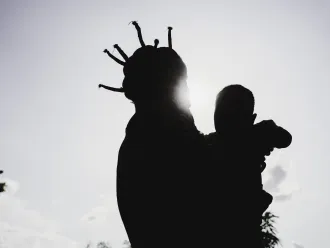 A girl holding a baby